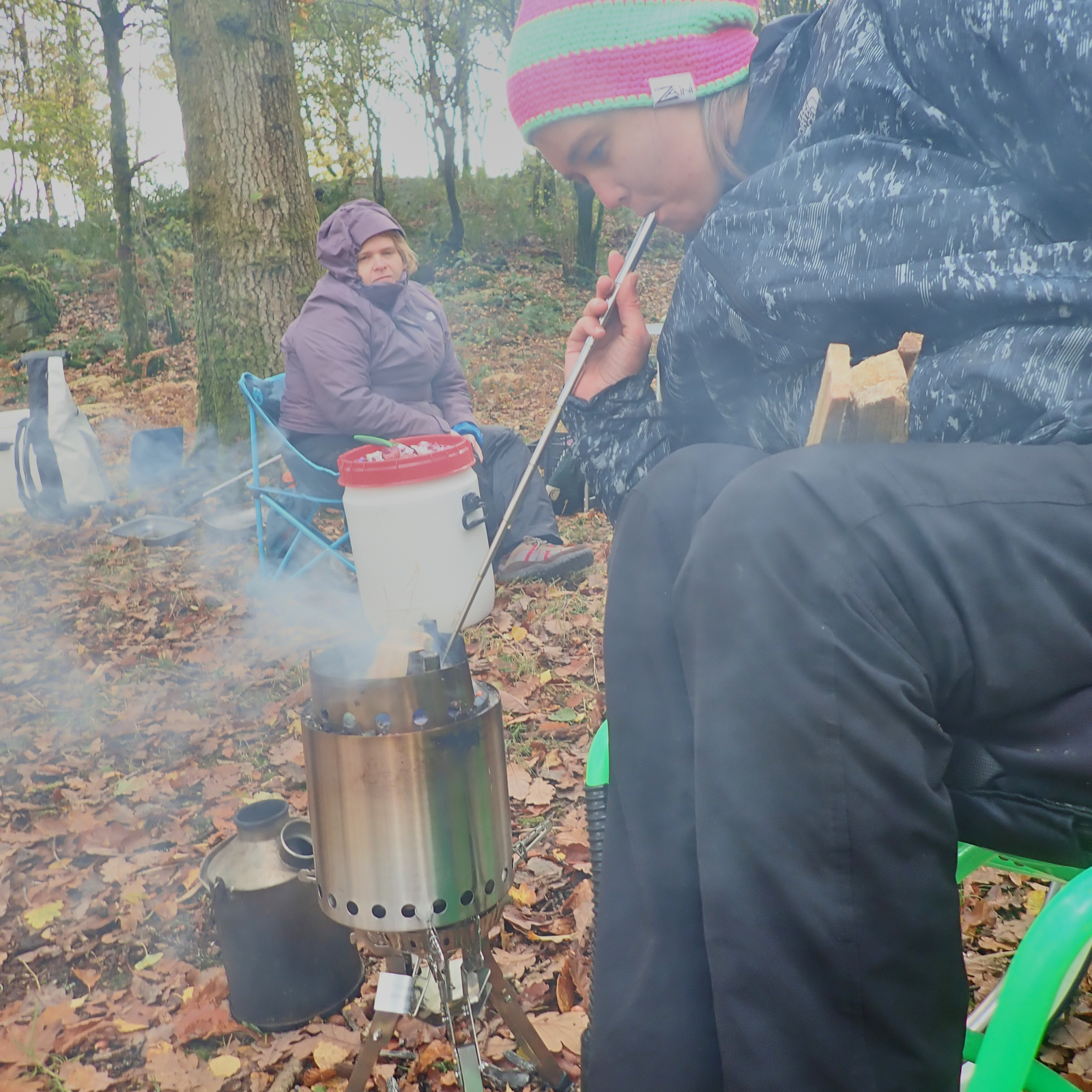 Cockpit of boat showing u shaped seating and large central wheel 