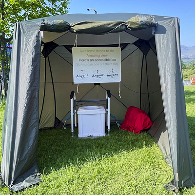 Portable toilet in. tent with handrails 