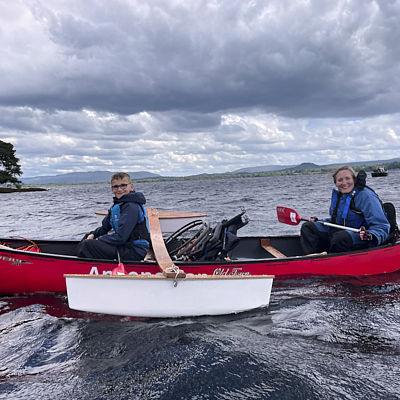 Caver crawls through a tight space 
