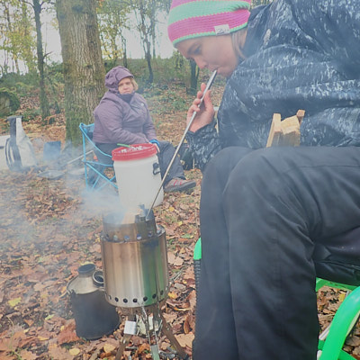 Man holds campfire pizza (very proud)