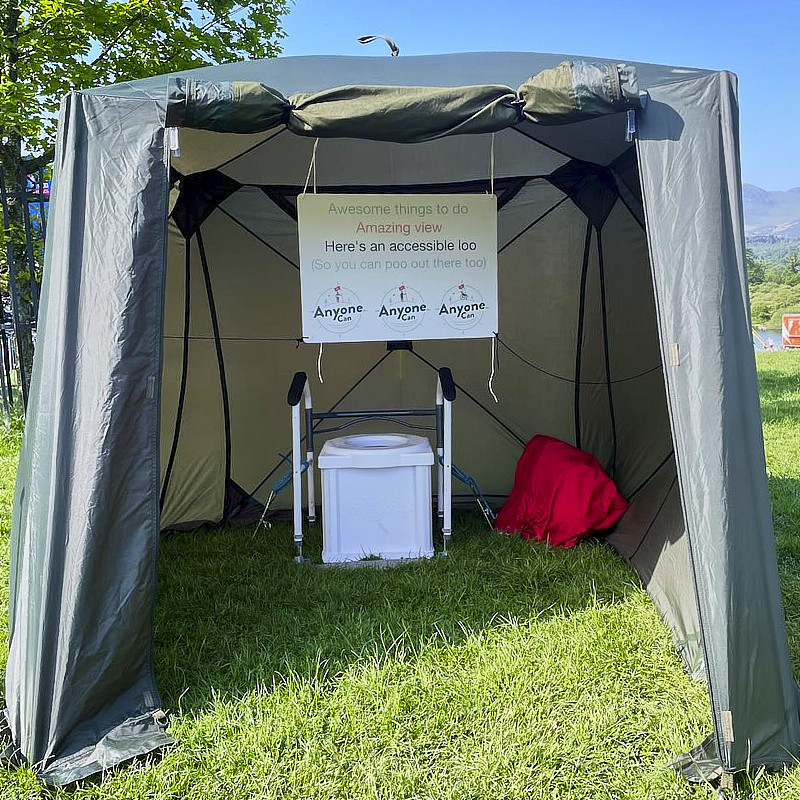 Cockpit of boat showing u shaped seating and large central wheel 