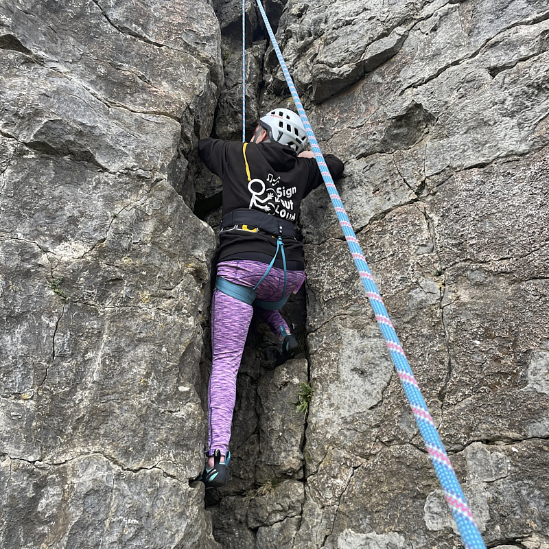 Cockpit of boat showing u shaped seating and large central wheel 