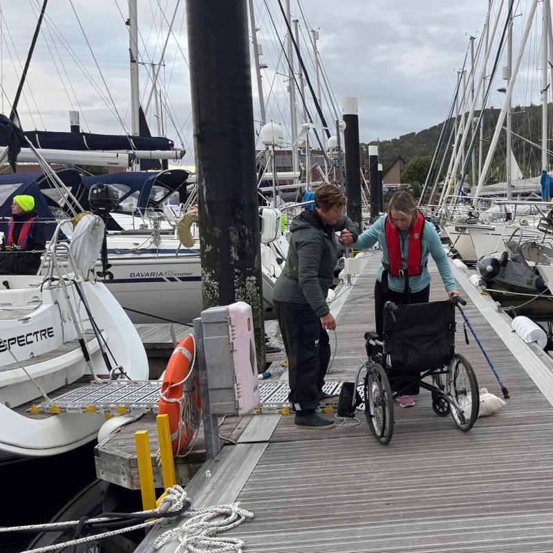 Lady reboards chari after transfering off the back of the yacht 