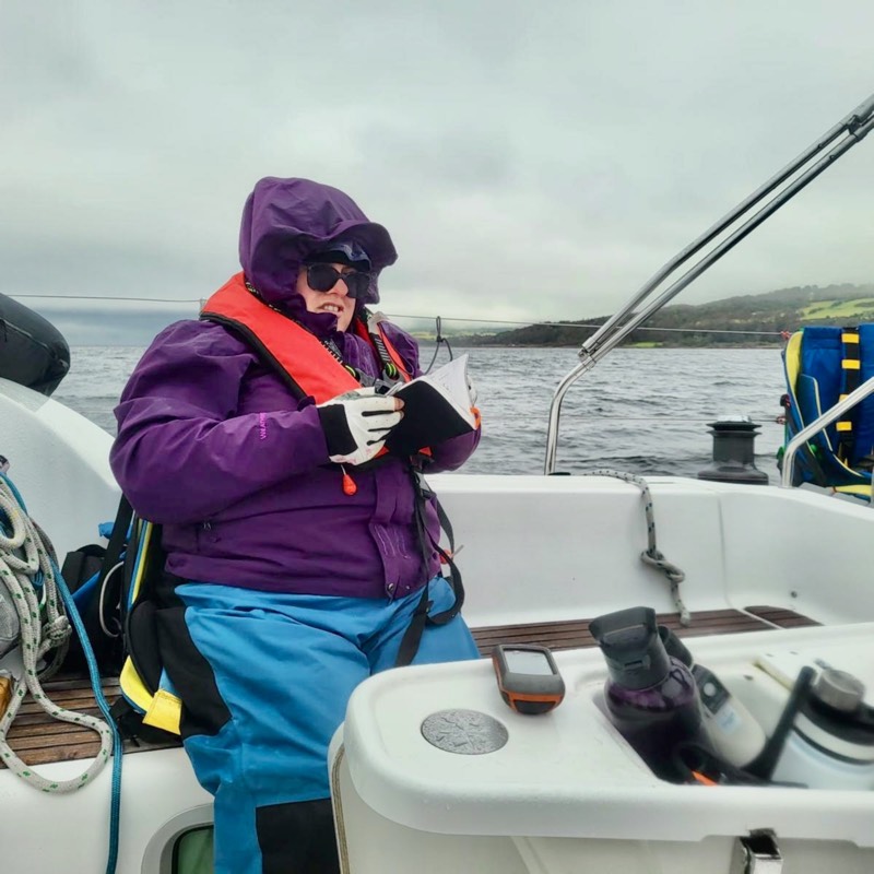 Yacht leaning in sunshine but it looks cold too 4 smiling crew