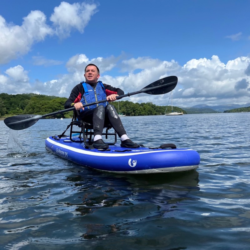 Canoeist with big sail if leanding hard and going fast
