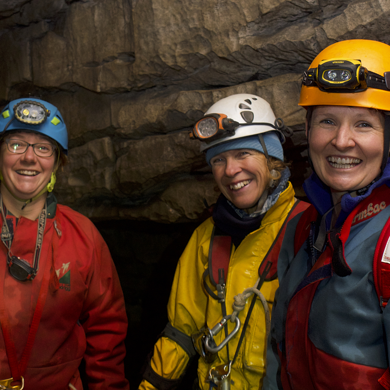 Smiling cavers look back at camera