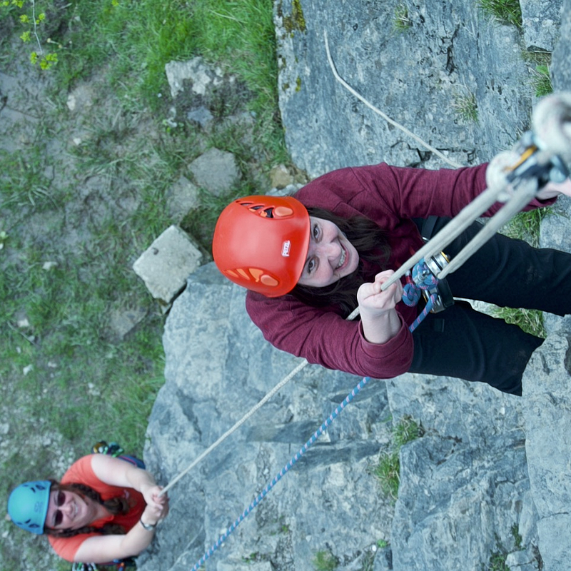 Cockpit of boat showing u shaped seating and large central wheel 