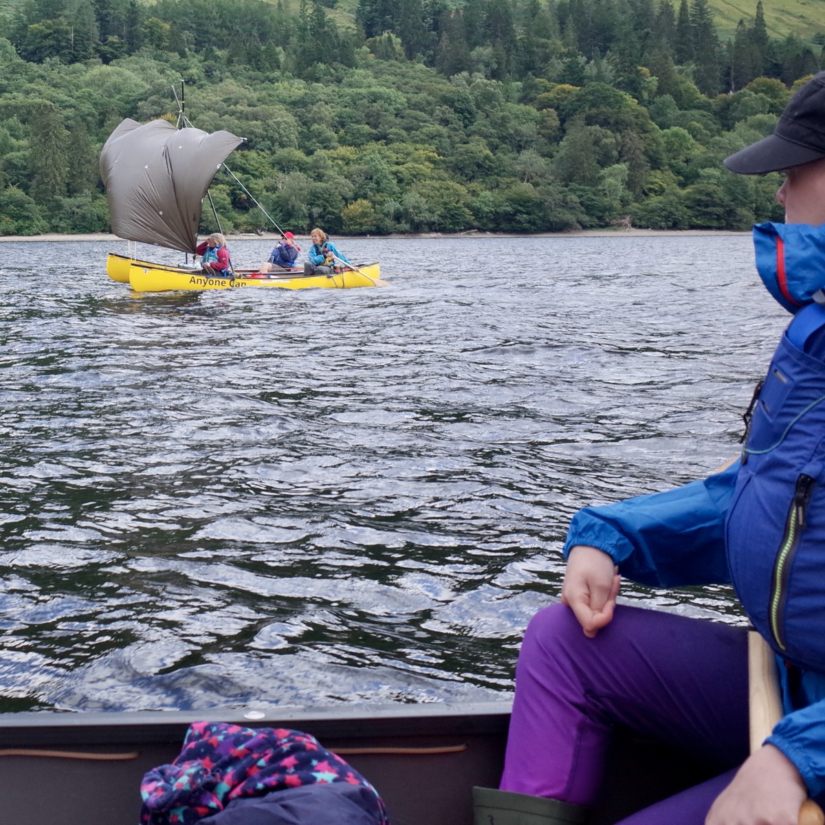 Canoe Sailng with full sails 