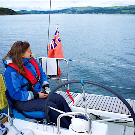sailor uses harness to access yacht