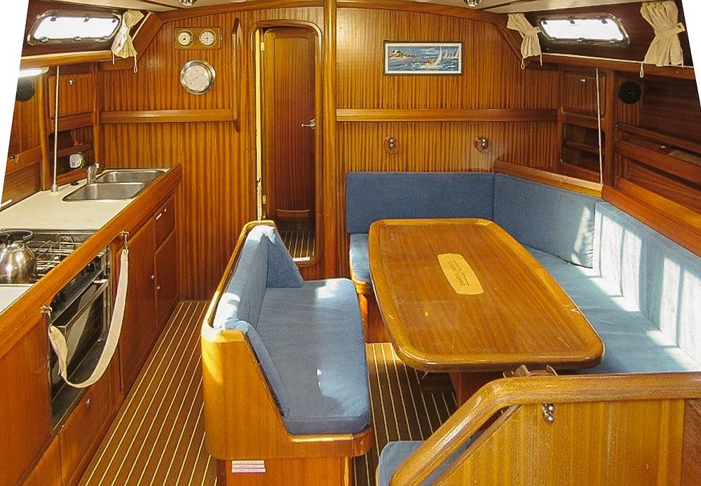 Showing the inner salloon with a gally down one side and seating round a table all in wood