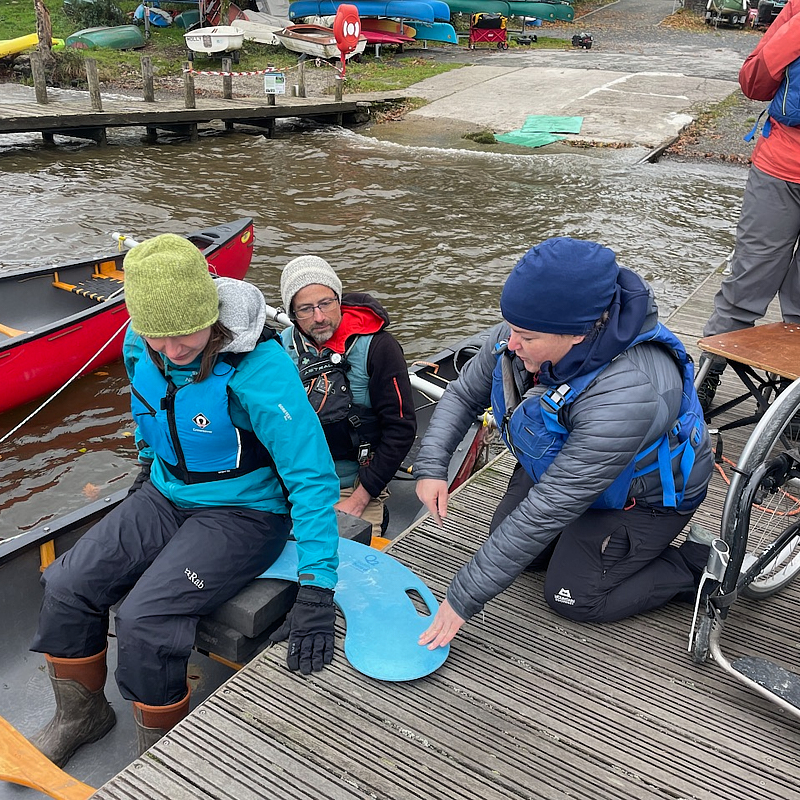 Wheel chair users sailing canoe