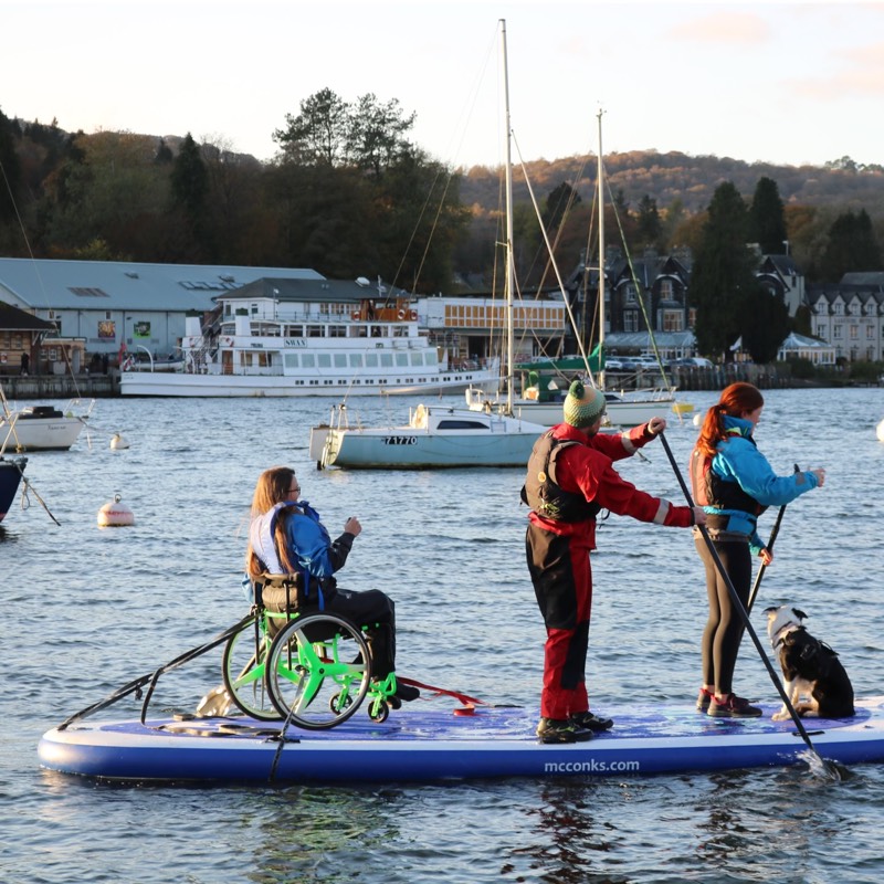 Sailing canoe and sailng dinghy cross paths. 