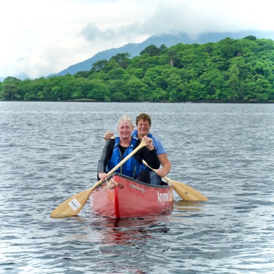 Two empty camping charis look out over the water