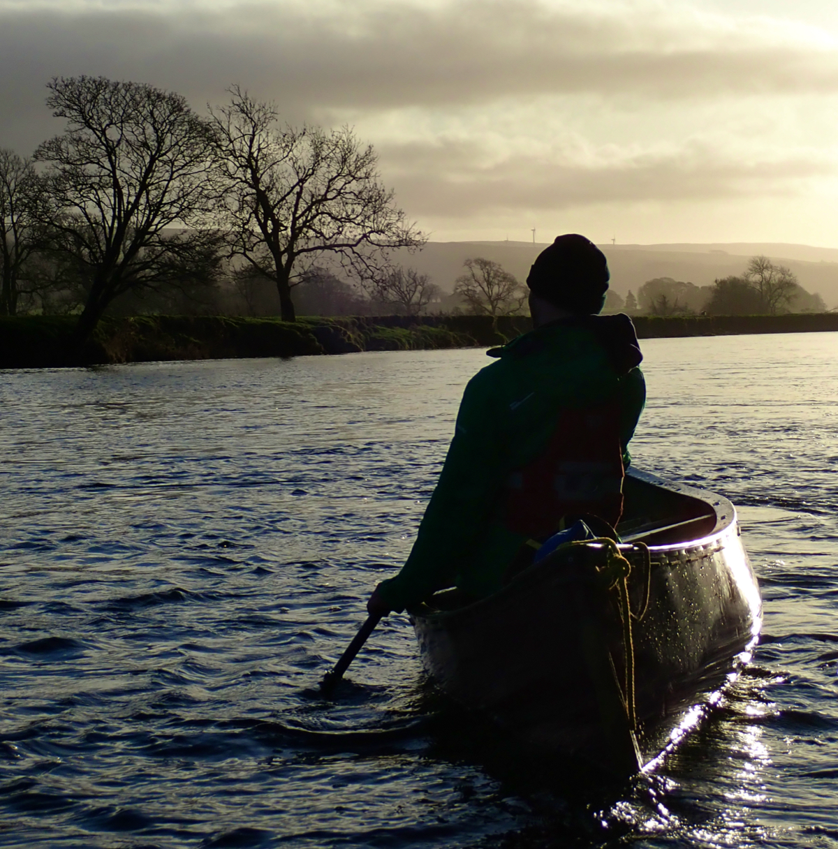 solo canoist into the sunset
