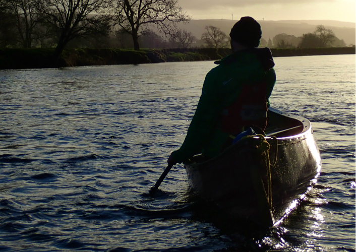 Paddling away in a canoe with stabilisers