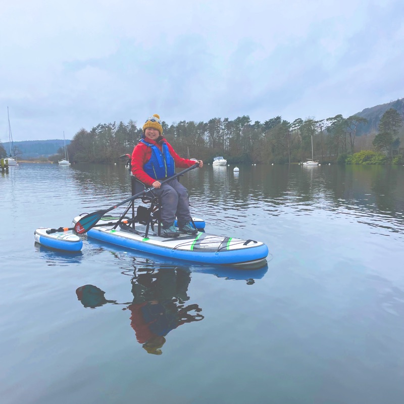 Green yacht surges under red sails